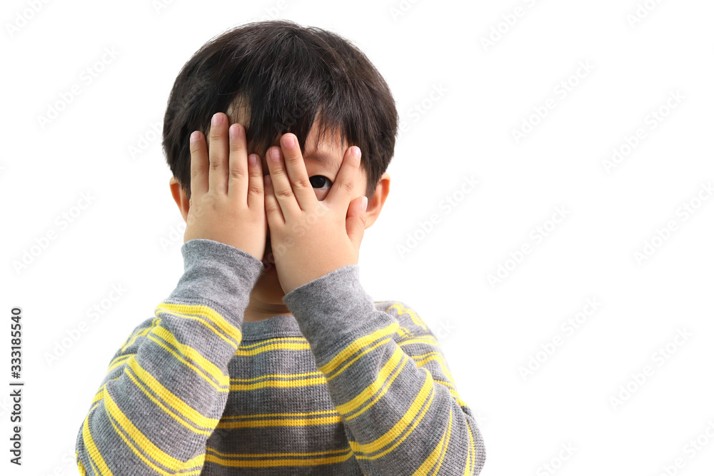 A cute Asian boy peeking over his little fingers over white background. A cute Asian boy peeking over his little fingers over white background.