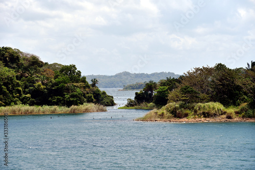 Green landscape of Panama Canal, view from the transiting cargo ship.