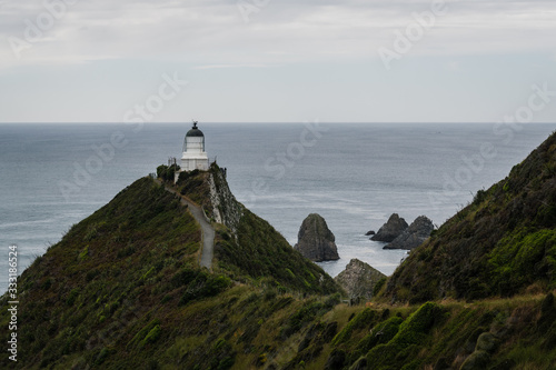 nugget point lighthouse on the coast photo