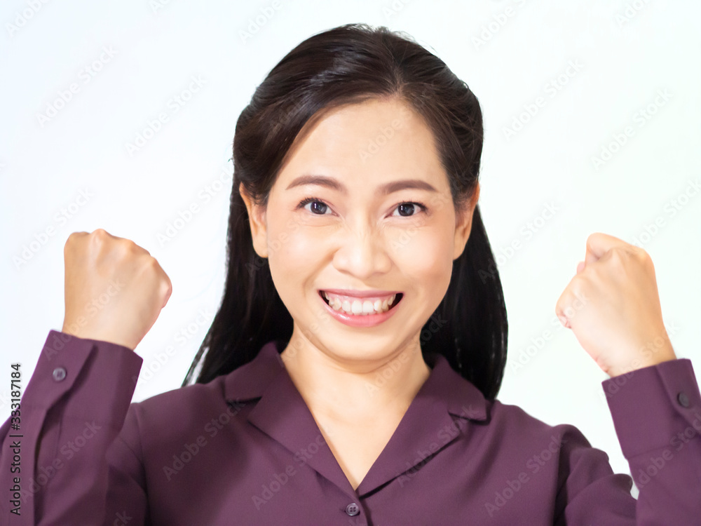 One excited asian bussiness woman has dark brown long hair and wear violet shirt. She is confidence, show two hands and is feeling satisfy and fight successful. Copy space white background. One excited asian bussiness woman has dark brown long hair and wear violet shirt. She is confidence, show two hands and is feeling satisfy and fight successful. Copy space white background.
