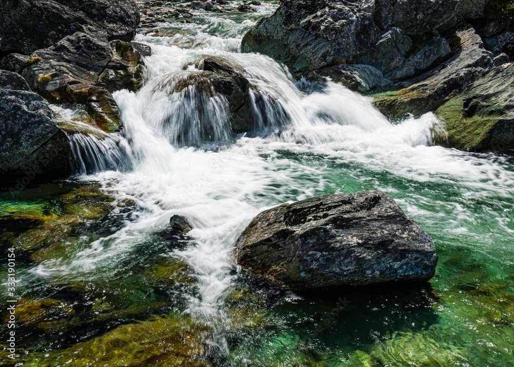 Fototapeta premium waterfall among the rocks in the forest