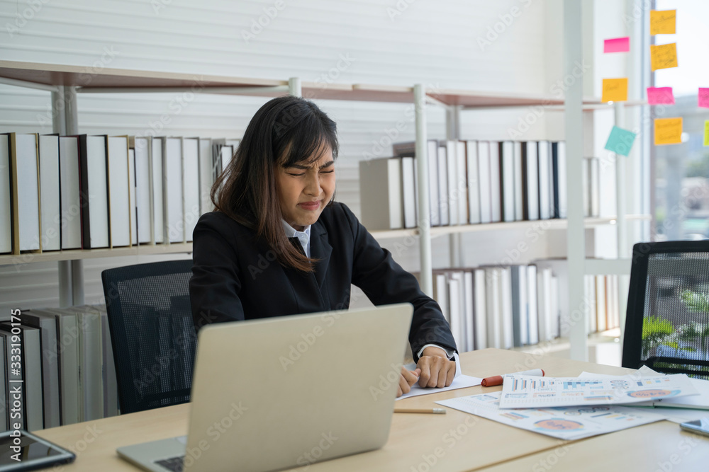 Asian business woman having problems in the office. Asian business woman having problems in the office.