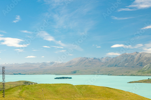 landscape with turquoise lake tekapo and mountains