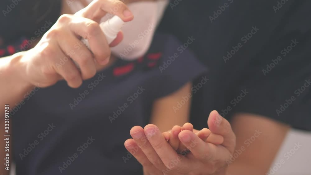 Caucasian father and daughter wipes hands with an alcohol-based hand-washing spray. Preventive measures against coronavirus ( Sars-CoV-2, Covid-19) infection with antibacterial hand sanitizer gel. Caucasian father and daughter wipes hands with an alcohol-based hand-washing spray. Preventive measures against coronavirus ( Sars-CoV-2, Covid-19) infection with antibacterial hand sanitizer gel.