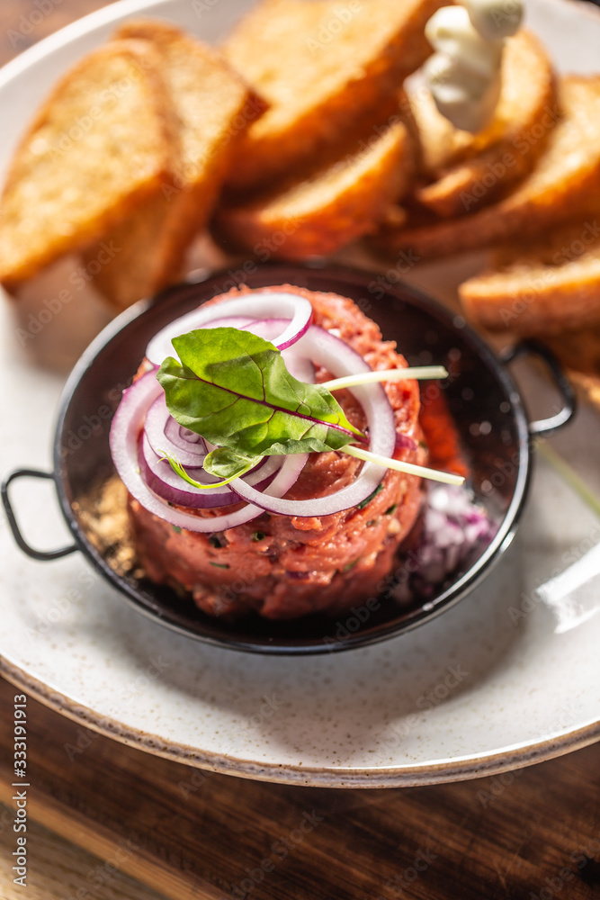 Beef tartare with red onion toast bread and garlic