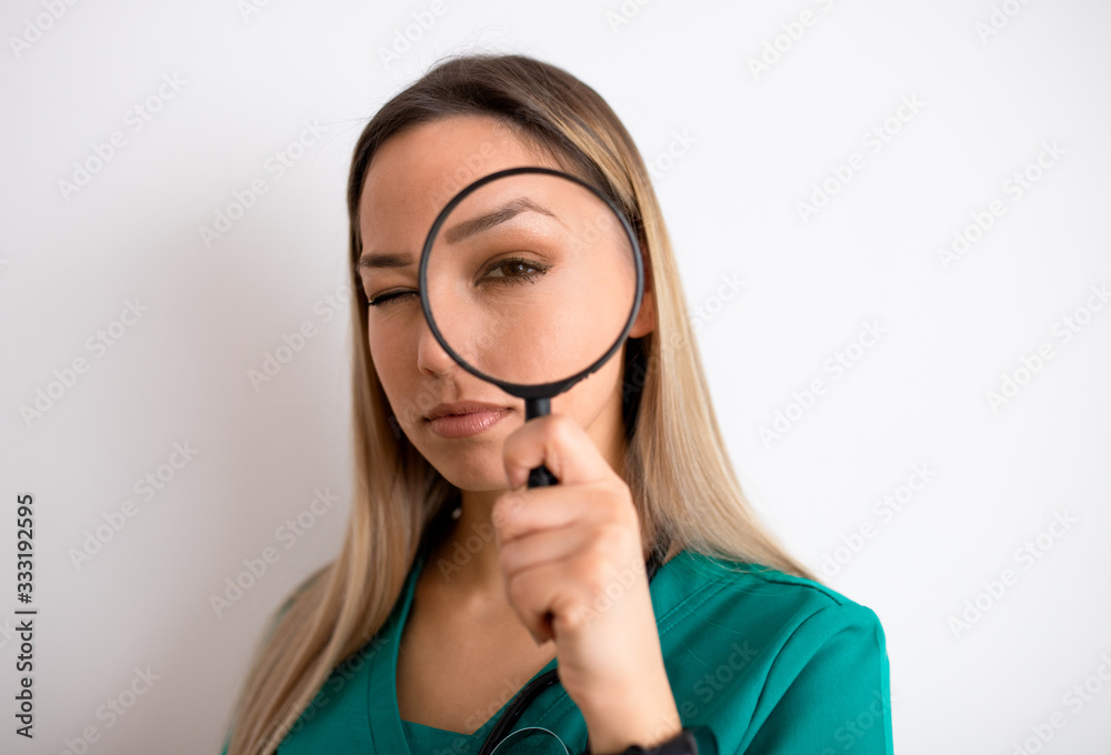 Woman looking through magnifying glass Woman looking through magnifying glass