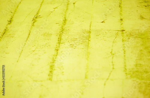 Fragment of old house wall close-up. Yellow background. Peeling plaster on concrete surface. Cracks in paint. tinted in yellow, warm colors backdrop. Copy space. Place for text. Selective focus image.