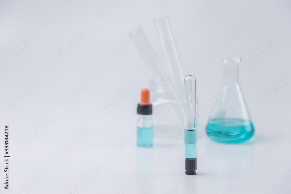 Flask,test tubes,dropper,mask with lab glassware in chemical and science laboratory , medical tools. Research and development concept. Flask,test tubes,dropper,mask with lab glassware in chemical and science laboratory , medical tools. Research and development concept.