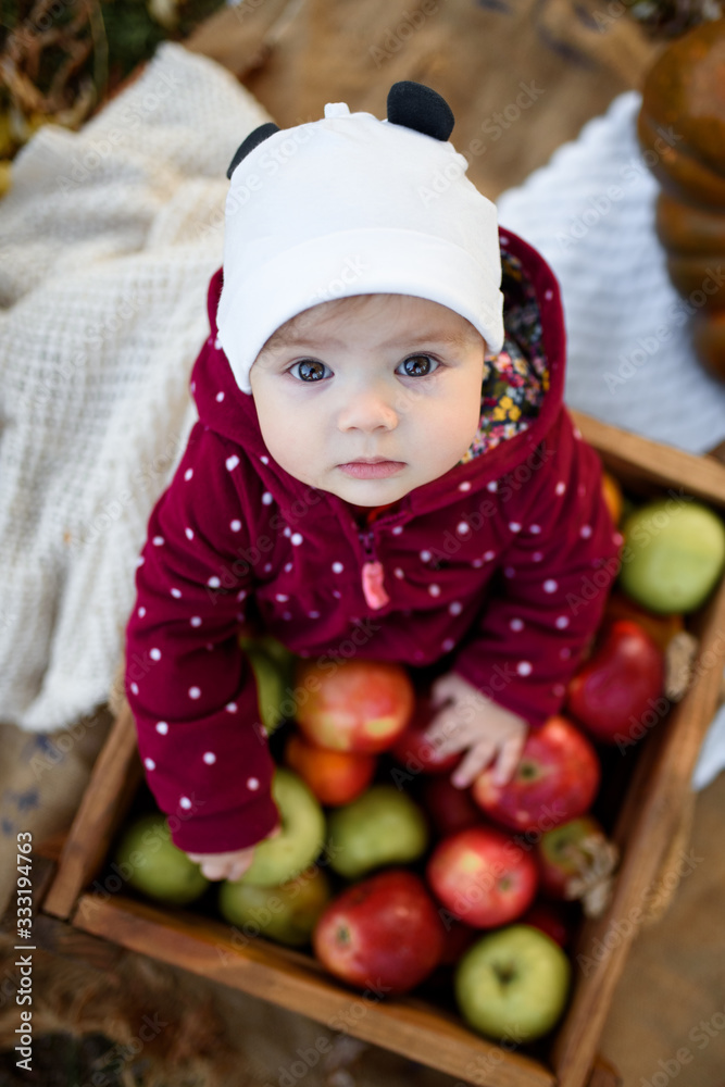 Little girl chooses an apple for the first feeding Little girl chooses an apple for the first feeding