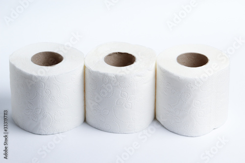 Three rolls of toilet paper on a light background photo