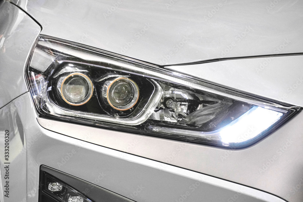 Samolepka Led headlight of a white modern car
