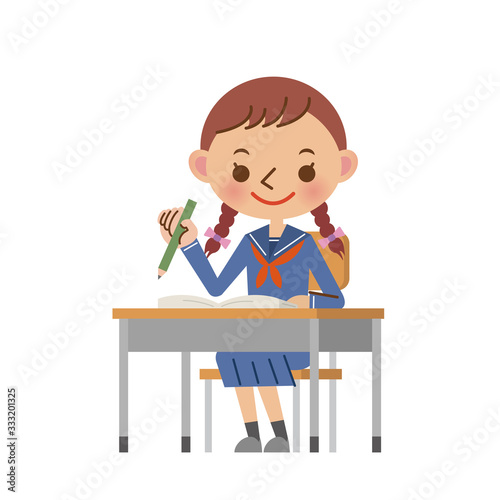 机に座って勉強をする女子中学生・高校生