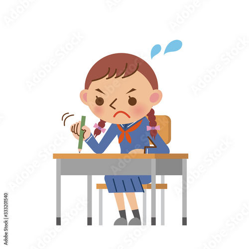 教室の机で必死に勉強する女子中学生・高校生