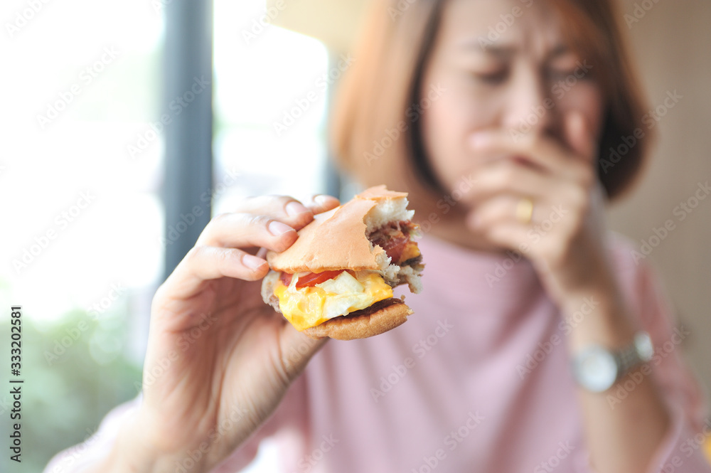 Dieting,Burger is heigh calories for dieting womenAsian girl refuses burger because she is controlling her calories,Selective focus Dieting,Burger is heigh calories for dieting womenAsian girl refuses burger because she is controlling her calories,Selective focus
