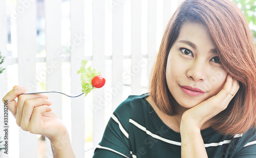 Wallpaper Mural Asian woman eating salad with happy mood smile on white background,Close up photo,Asian woman love to eating vegetable Torontodigital.ca