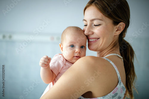 Beautiful mother and her newborn baby together. Love, happiness, family concept.