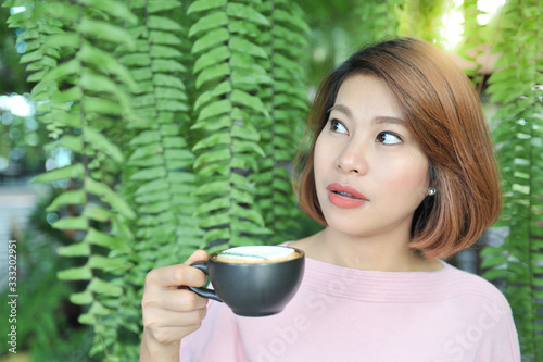 Wallpaper Mural Asian women enjoy drinking coffee in the garden with sunlight background,selective focus Torontodigital.ca