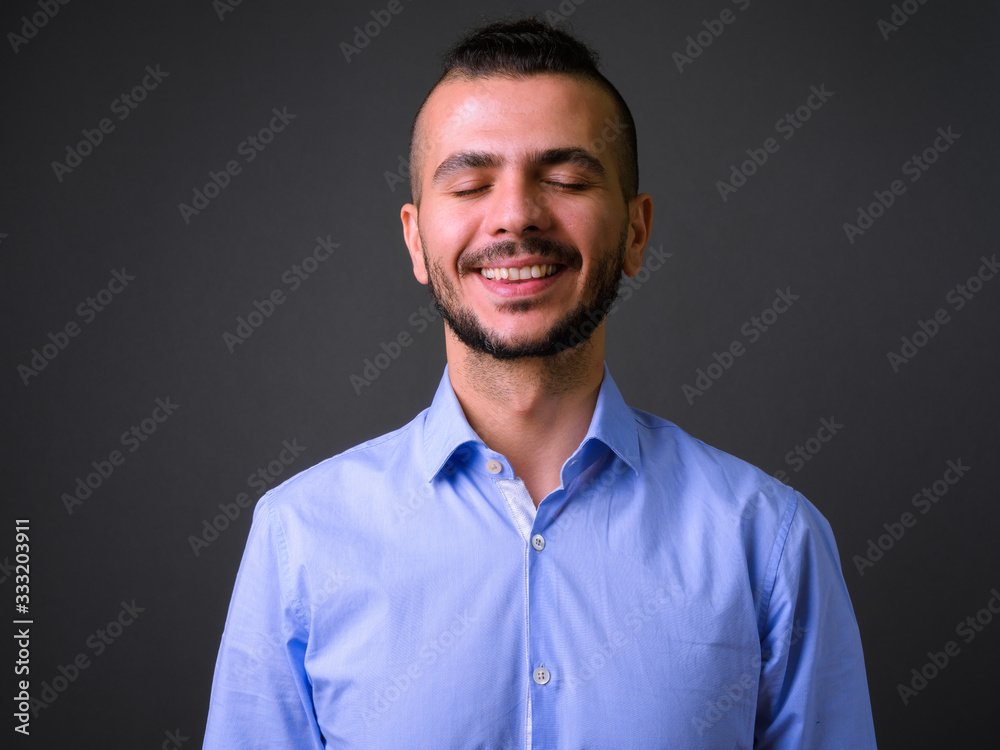 Face of happy bearded Turkish businessman with eyes closed Face of happy bearded Turkish businessman with eyes closed