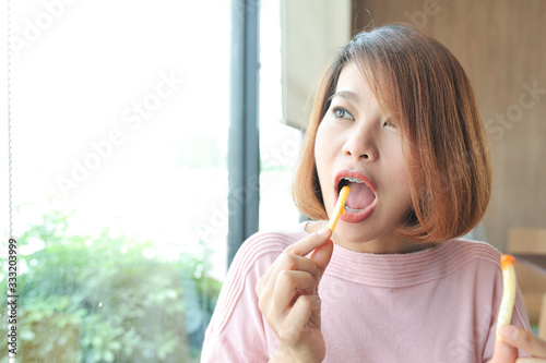 Wallpaper Mural Women choose to eat French fries with chili sauce,Selective focus Torontodigital.ca
