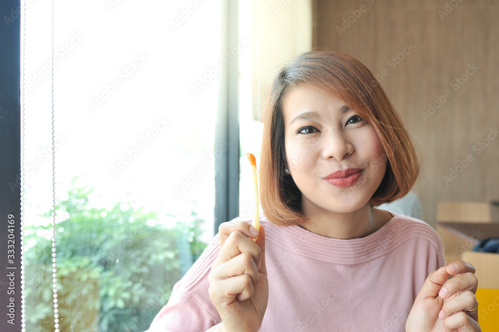 custom made wallpaper toronto digitalAsian women smile and enjoy her lunch with eatting french fries,selective focus