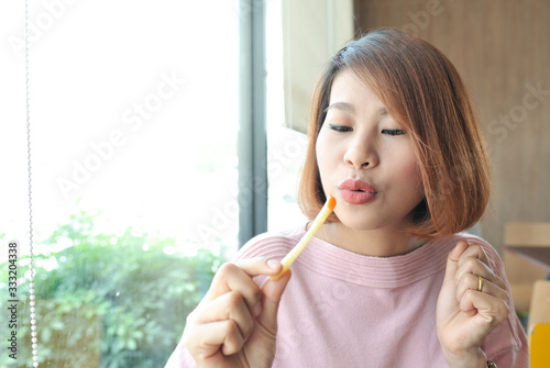 Wallpaper Mural Women happy with french fries in her hands,Pink shirt women greeful for her french fries,Selective focus Torontodigital.ca