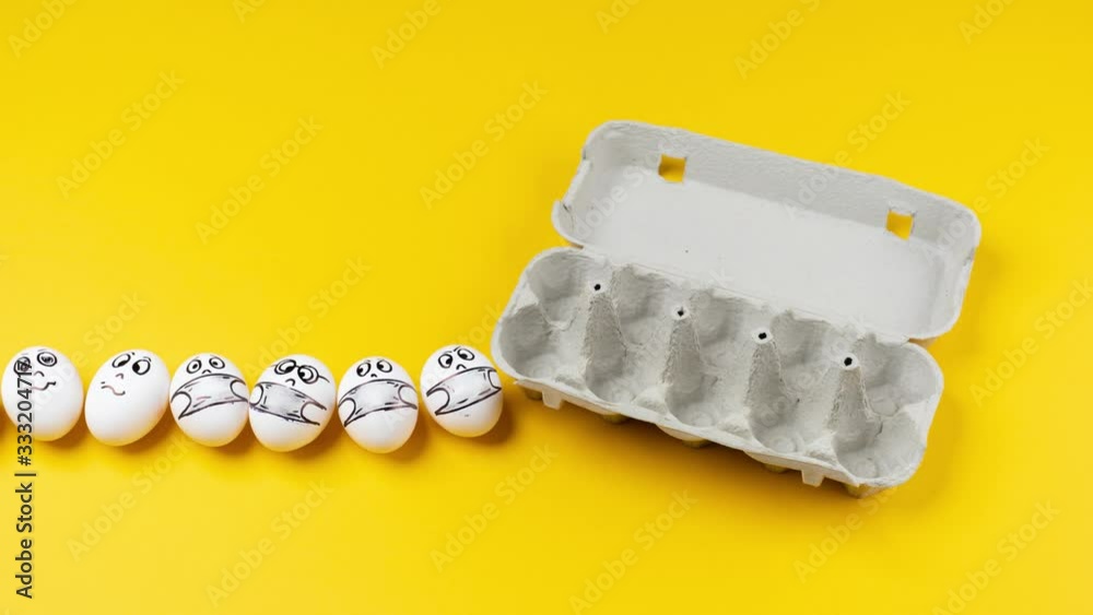 Eggs with faces in respiratory masks move in a cardboard box on a yellow background. Emotions on the face of eggs. Stop motion animation Eggs with faces in respiratory masks move in a cardboard box on a yellow background. Emotions on the face of eggs. Stop motion animation