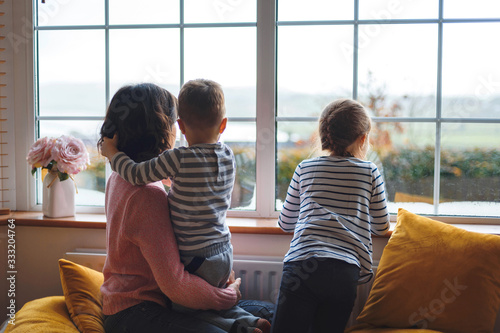 mother with two children at window