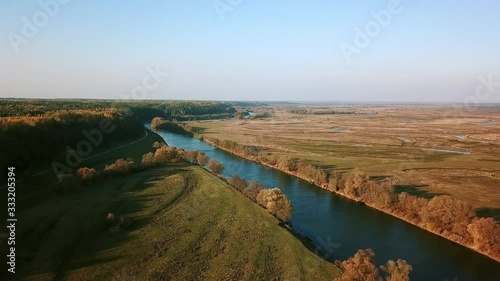 aerial view of river and meadows in autumn, Stunning aerial shot over lush autumn fields and meadows in the countryside, Sunny autumn day in a nature park photo