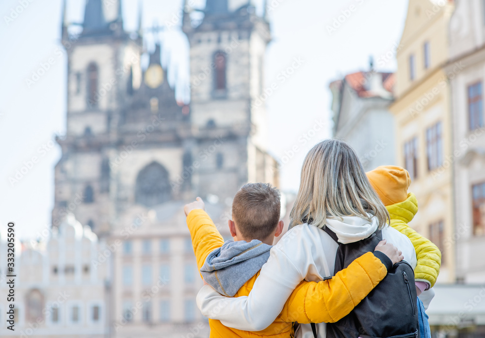 Happy family stands on the Old Town Square in Prague. Empty space for text Happy family stands on the Old Town Square in Prague. Empty space for text