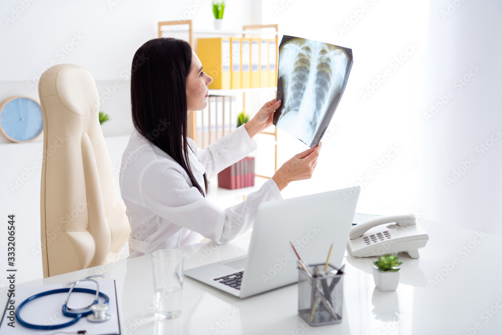 Photo of beautiful doctor radiologist lady look learn watch human ...