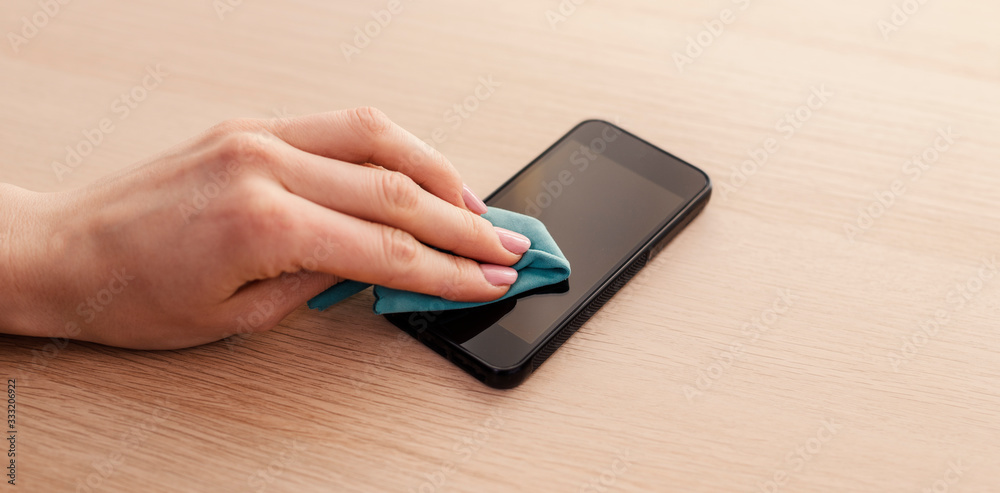 Smartphone screen cleaning with a microfiber wipe and antiseptic liquid Smartphone screen cleaning with a microfiber wipe and antiseptic liquid