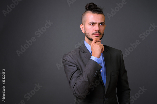 Portrait of handsome bearded Turkish businessman in suit thinking © Ranta Images
