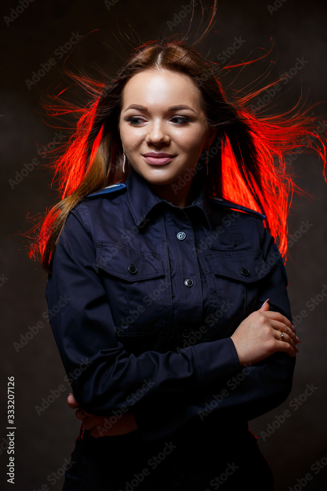 portrait of a beautiful girl in police uniform. Professional posing