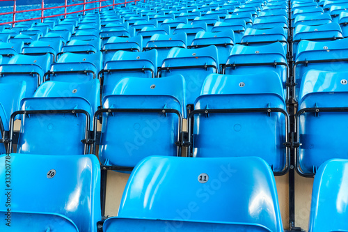 empty bleachers and chairs in blue