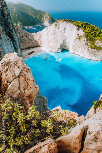 Navagio beach from top rocks at Zakynthos island, Greece. Stranded freightliner ship in unique beautiful blue lagoon and rocky mountains