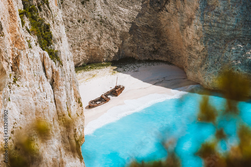 Close up of Navagio beach called Shipwreck bay. Turquoise water and pebble white beach and limestone walls. Famous landmark location on Zakynthos island, Greece photo