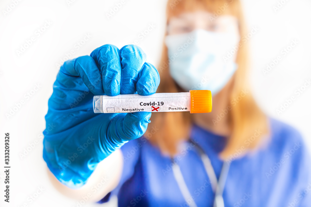eine Ärztin hält ein Abstrichröhrchen mit Coronavirus in der Hand eine Ärztin hält ein Abstrichröhrchen mit Coronavirus in der Hand