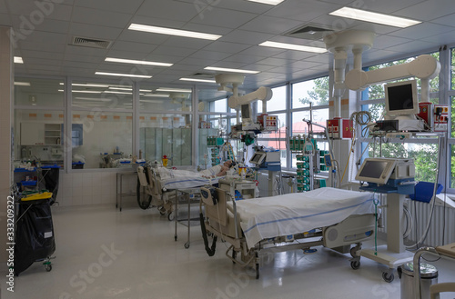Photos Intensive care unit in hospital, beds with monitors, ventilators, a place where can be  treated patients with pneumonia caused by coronavirus covid 19