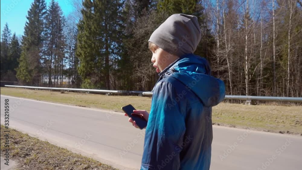 boy with a smartphone outdoors portrait. boy with a smartphone outdoors portrait.