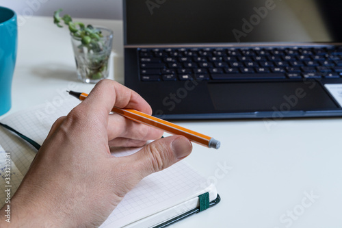 Man working on laptop, close up hands