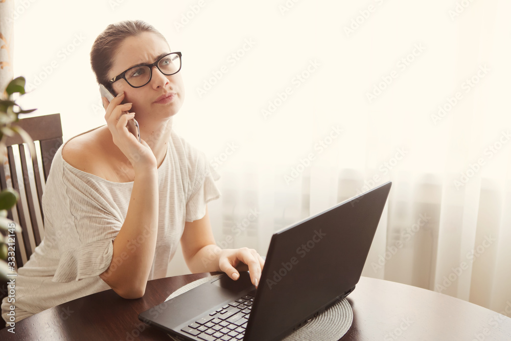 Young concentrated woman enjoying work on laptop. Positive female student doing homework, watching online webinar, listening audio course, writing emails, distantly working with wifi Young concentrated woman enjoying work on laptop. Positive female student doing homework, watching online webinar, listening audio course, writing emails, distantly working with wifi