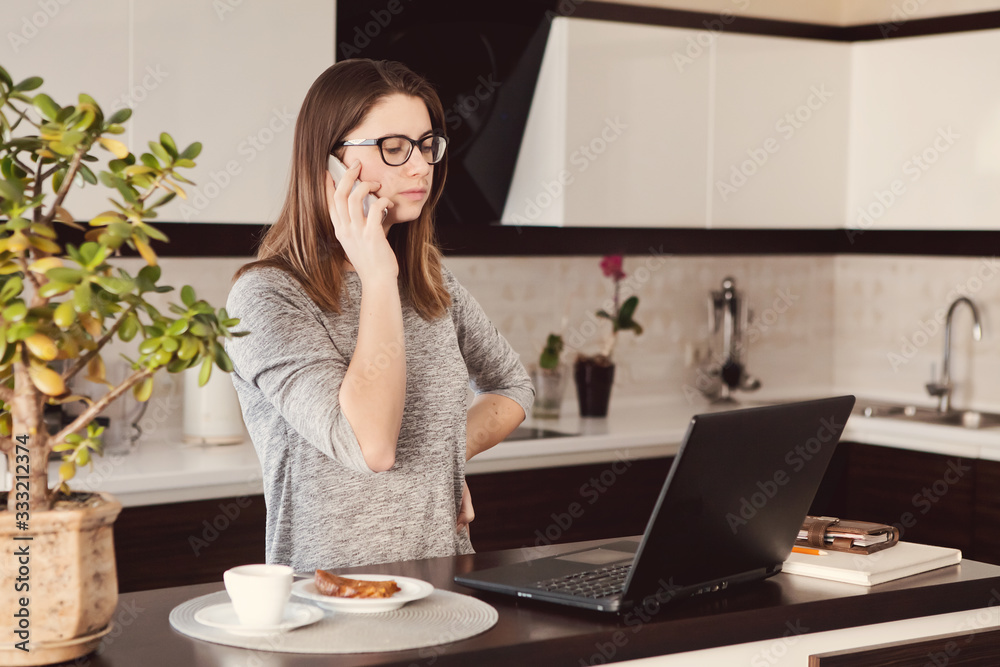 Young concentrated woman enjoying work on laptop. Positive female student doing homework, watching online webinar, listening audio course, writing emails, distantly working with wifi Young concentrated woman enjoying work on laptop. Positive female student doing homework, watching online webinar, listening audio course, writing emails, distantly working with wifi