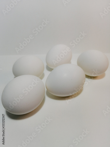 five white eggs on a white background