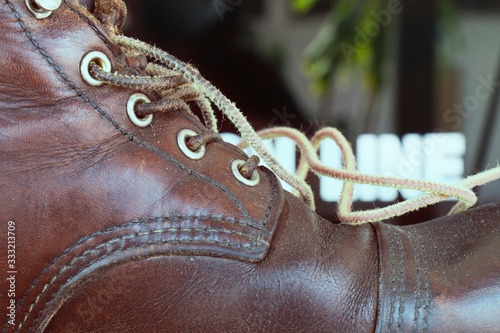 The brown leather shoelaces, lacing
