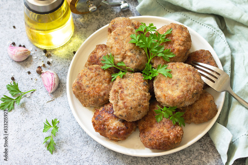 Tableau sur toile Homemade juicy delicious meat cutlets in plate, meatballs from minced meat on a gray stone table