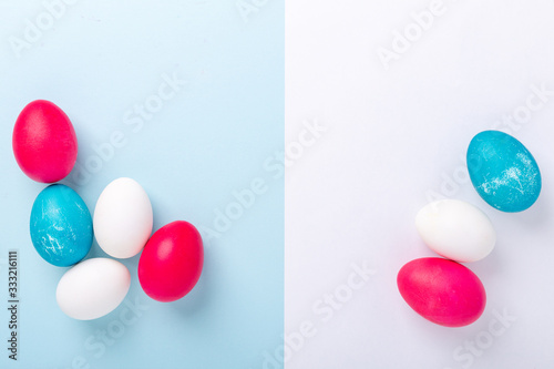 Easter composition with eggs and blank of white paper on blue background. Easter concept. Copy space. Top view