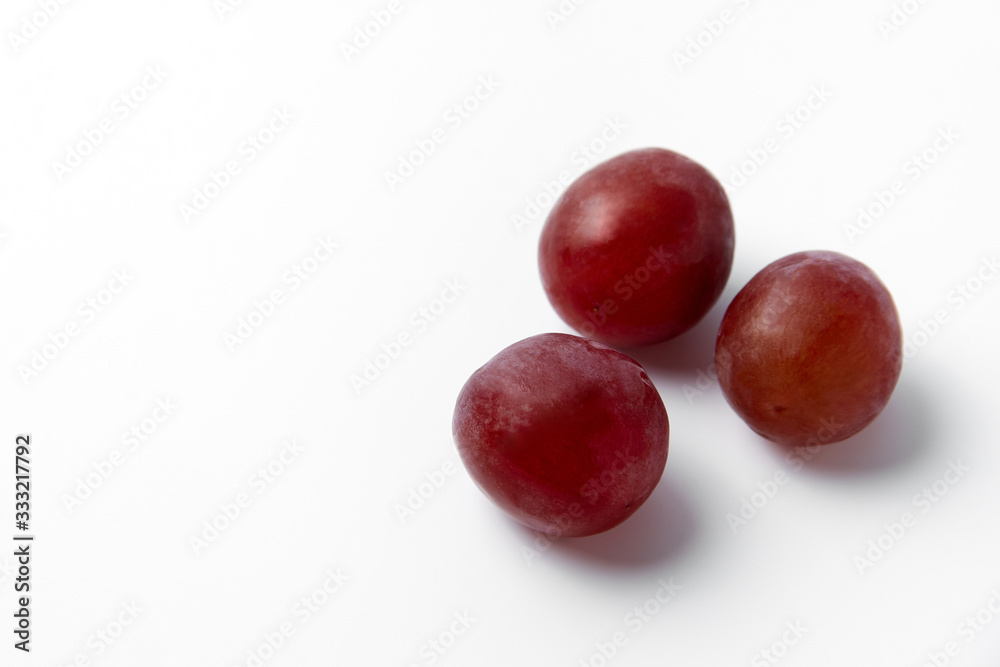 Red grape berries on a white background Red grape berries on a white background