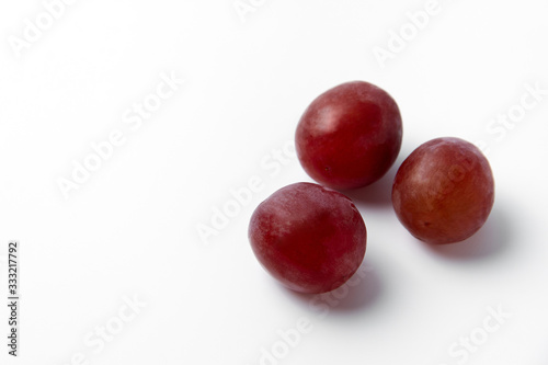 Red grape berries on a white background © Рустам Мухомедьяров