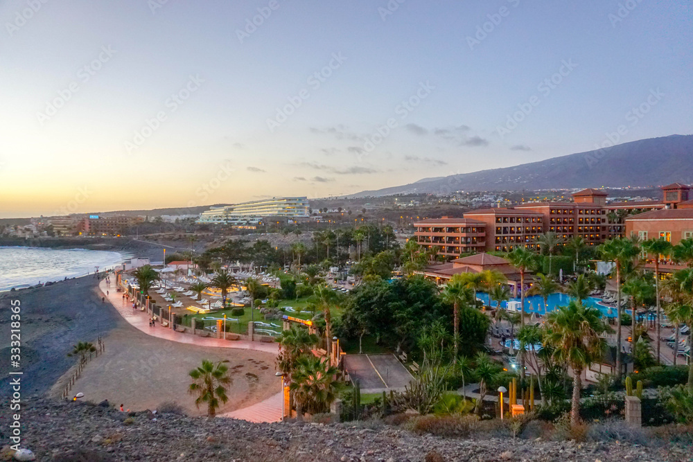 Tenerife,Canary Islands,Spain - July 23, 2019: Panoramic view of the seafront hotel H10 Costa Adeje Palace with the direct access to Playa de La Enramada beach 