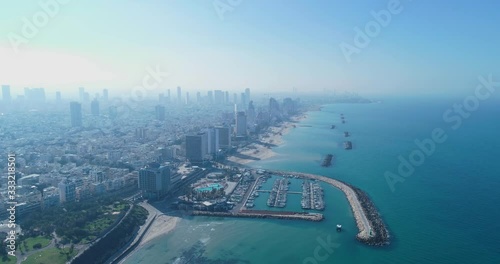 Israel skyline from a drone. Panoramic Aerial view above coastline of Tel Aviv modern and business city with hotels, seashore and beach. Middle east skylines